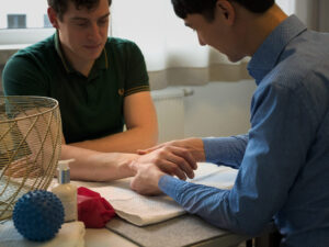 Mann bei einer Ergotherapie Behandlung seiner Hand